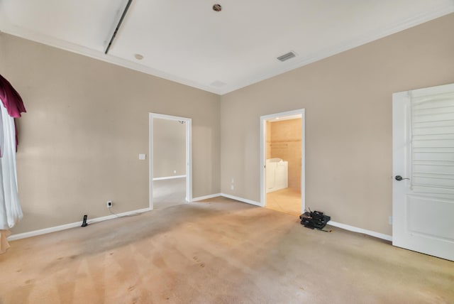 carpeted empty room featuring crown molding