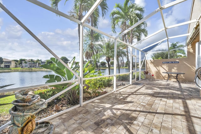 unfurnished sunroom featuring a water view