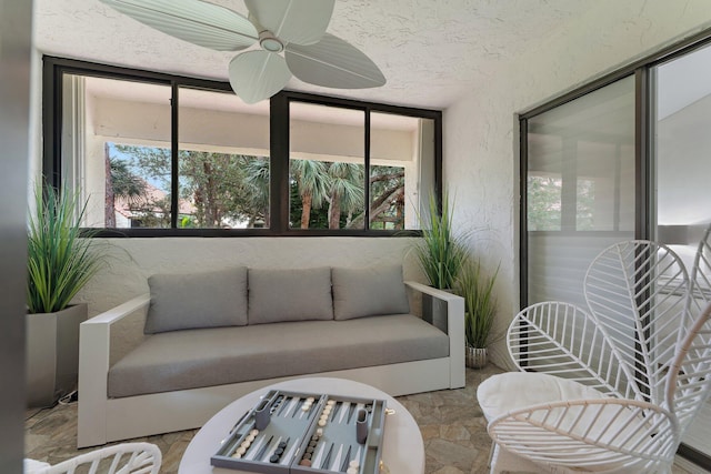 sunroom featuring plenty of natural light and ceiling fan