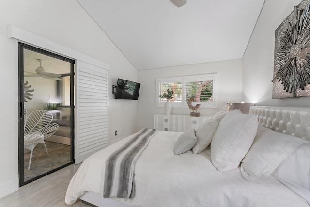 bedroom with lofted ceiling and light wood-type flooring