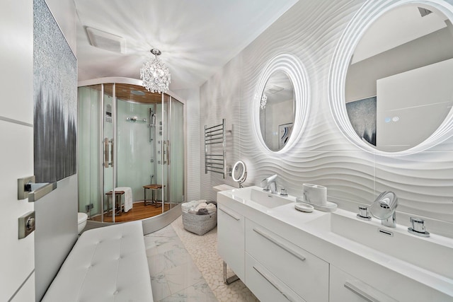 bathroom with vanity, a shower with shower door, and toilet