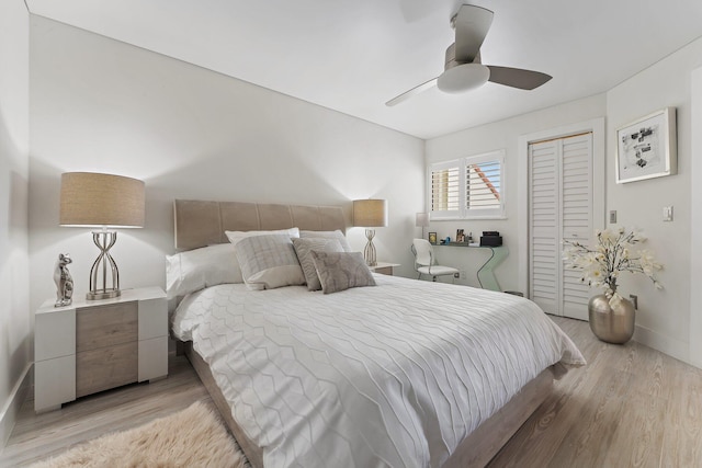 bedroom featuring ceiling fan, light wood-type flooring, and a closet