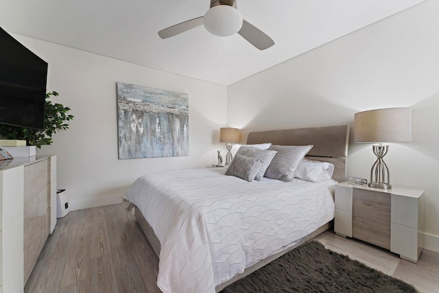 bedroom with ceiling fan and light hardwood / wood-style floors