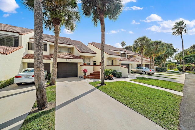 mediterranean / spanish house with a garage and a front yard