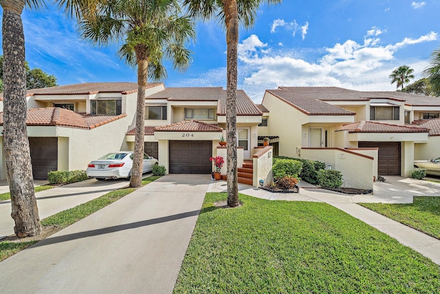 view of front of house featuring a garage and a front lawn