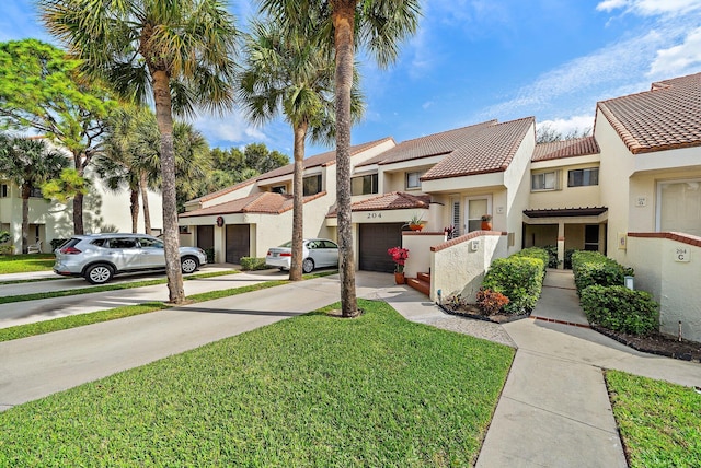 view of front of property with a garage and a front yard