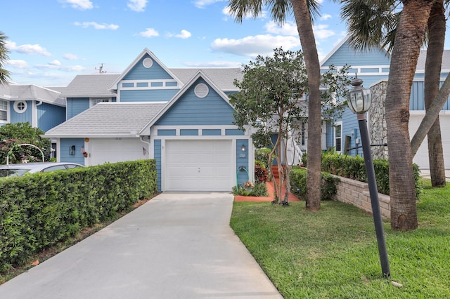 view of front of house with a garage and a front lawn