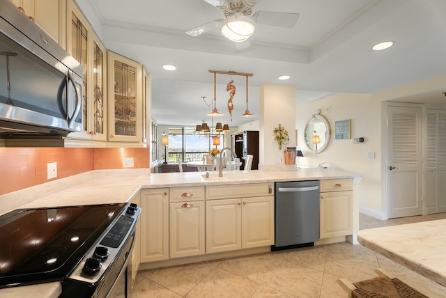 kitchen featuring sink, stainless steel appliances, tasteful backsplash, decorative light fixtures, and kitchen peninsula