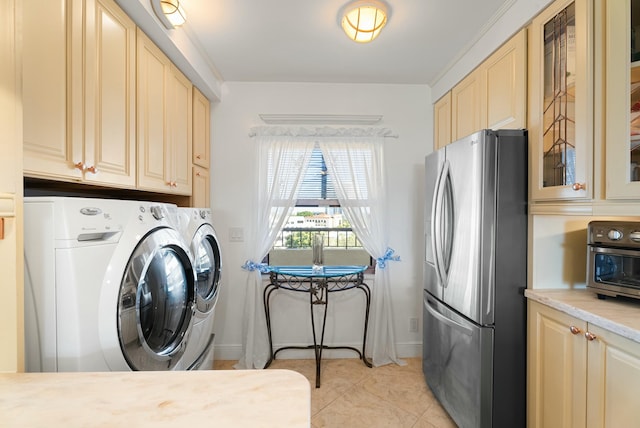 washroom with washer and dryer and light tile patterned floors