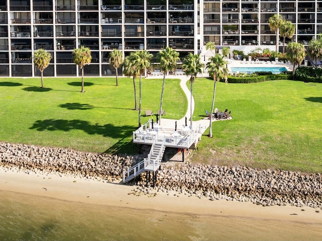 view of home's community featuring a water view and a yard