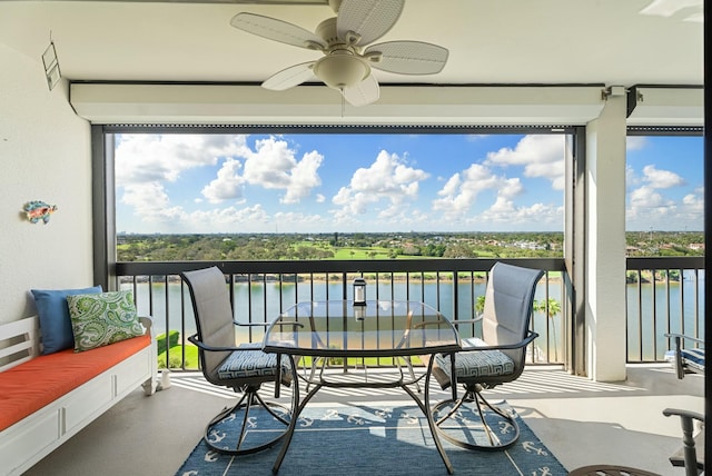 sunroom / solarium featuring a water view, ceiling fan, and a healthy amount of sunlight