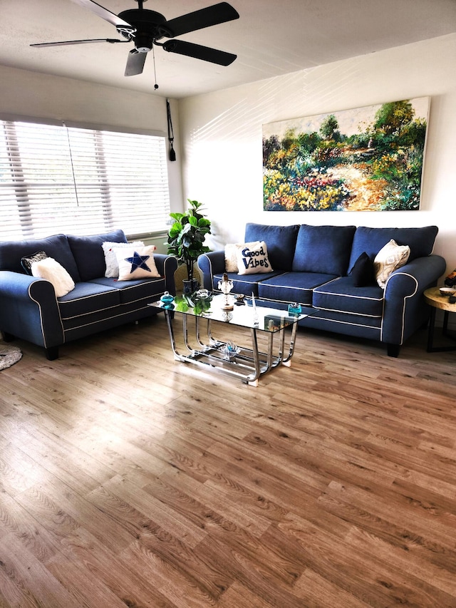 living room with hardwood / wood-style flooring and ceiling fan