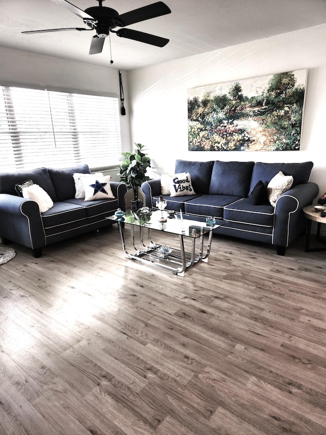 living area featuring wood finished floors and a ceiling fan