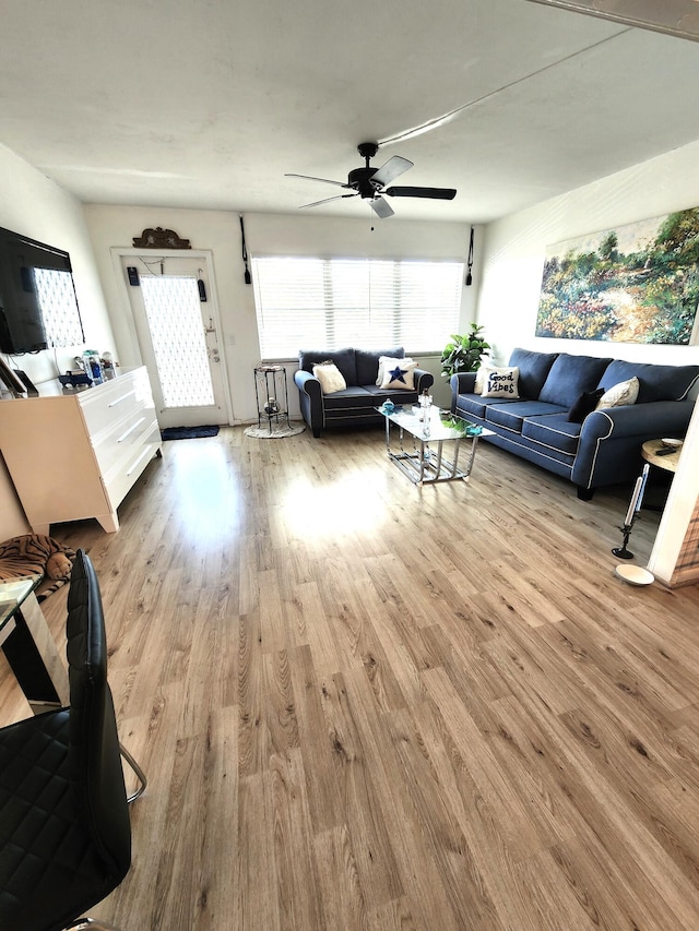 living area with ceiling fan and wood finished floors