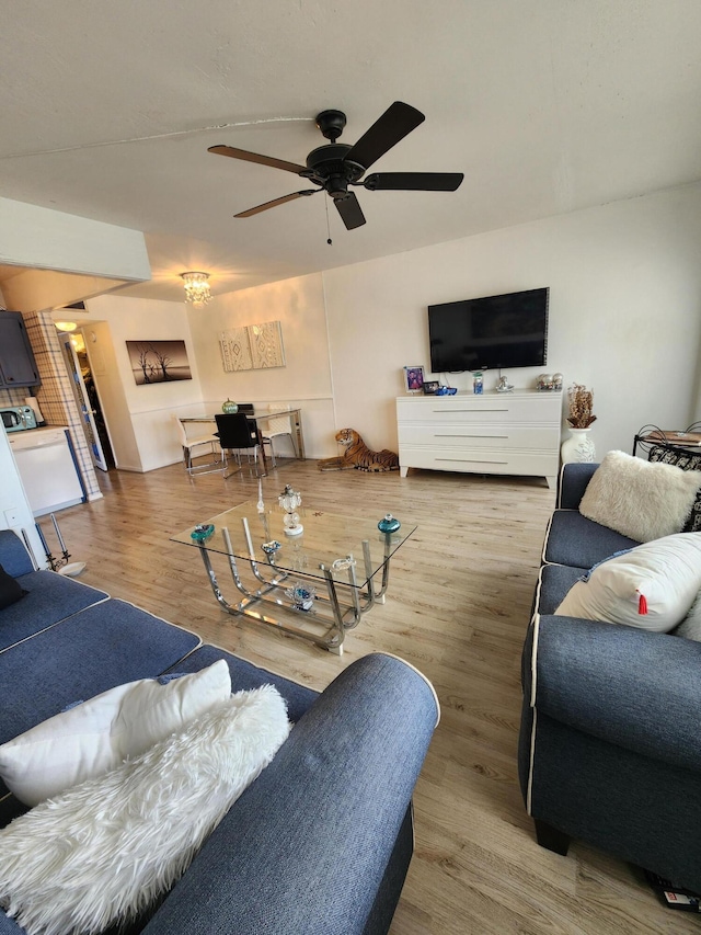 living area with ceiling fan and wood finished floors