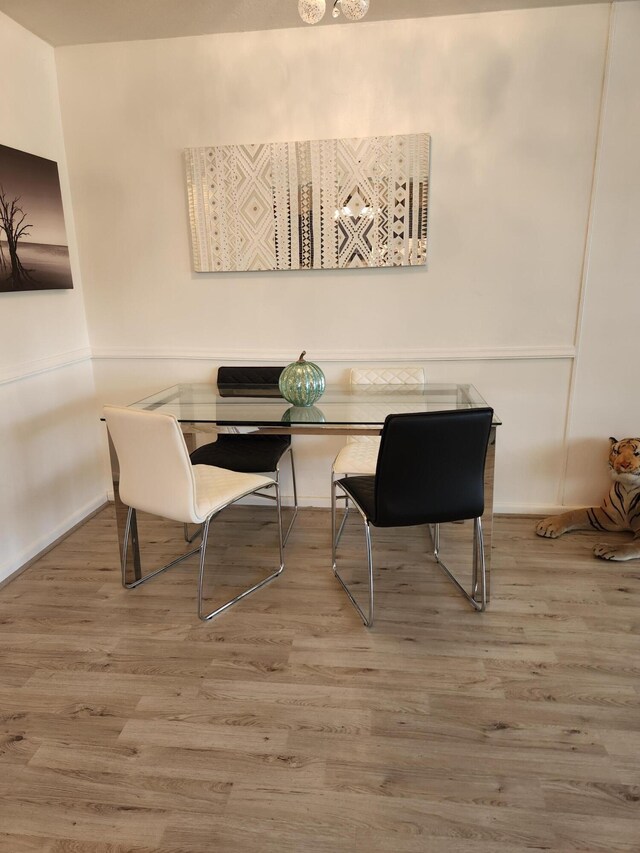 kitchen featuring pendant lighting, sink, white appliances, and light hardwood / wood-style flooring