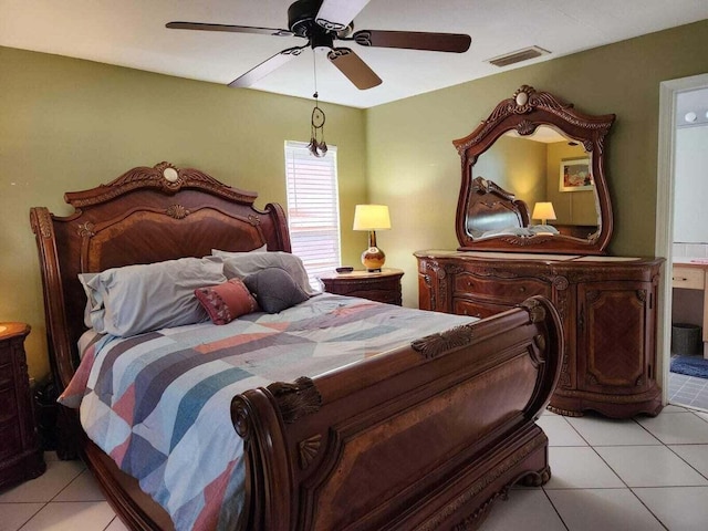 bedroom with ensuite bathroom, ceiling fan, and light tile patterned flooring