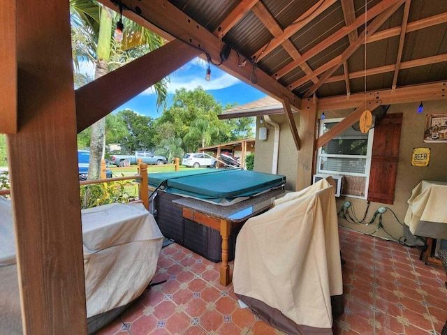 view of patio with a grill and a hot tub