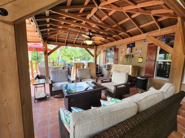 view of patio featuring a gazebo, ceiling fan, and outdoor lounge area