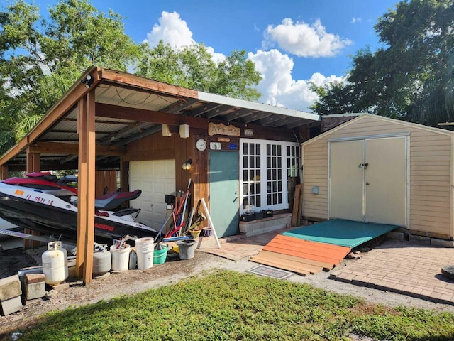 view of outdoor structure featuring french doors and a garage