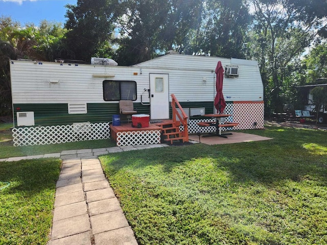 rear view of house with a yard and a patio