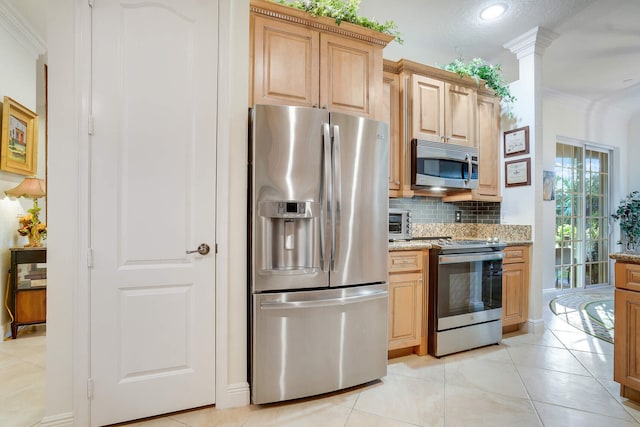 kitchen featuring light stone countertops, appliances with stainless steel finishes, light tile patterned floors, and decorative backsplash