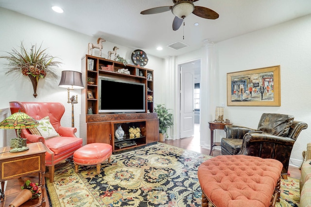 living room featuring hardwood / wood-style flooring and ceiling fan