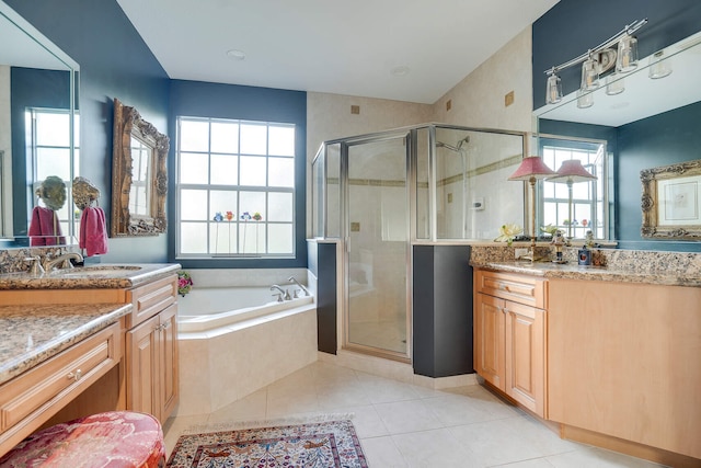 bathroom with independent shower and bath, vanity, and tile patterned floors