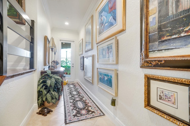 hall featuring light tile patterned floors and ornamental molding