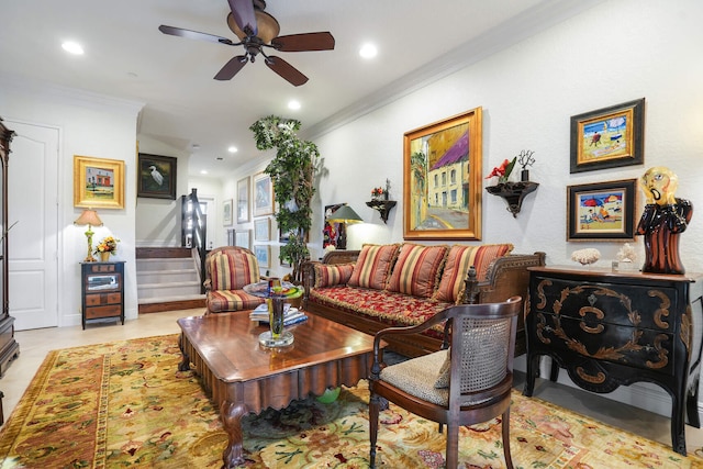 living room with light tile patterned floors, crown molding, and ceiling fan