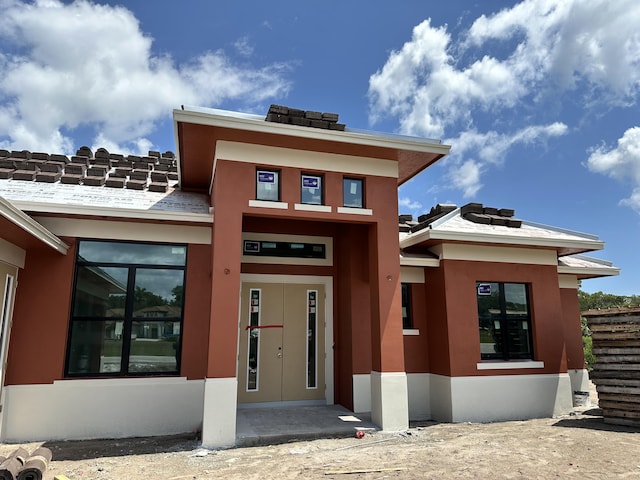 view of front of house featuring stucco siding
