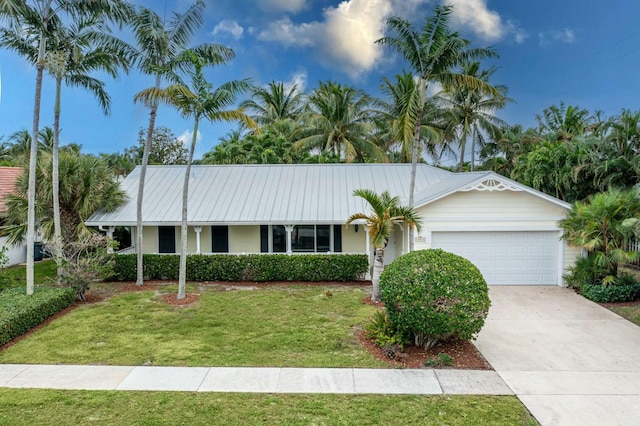 ranch-style home with a garage and a front lawn