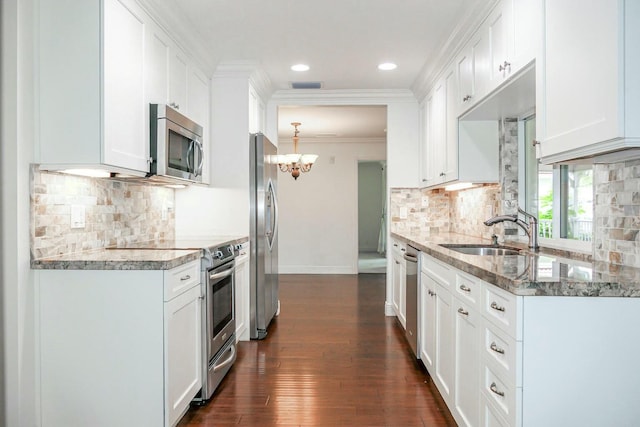 kitchen featuring appliances with stainless steel finishes, sink, white cabinets, and light stone counters