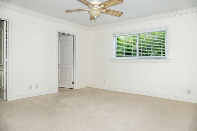 unfurnished room with crown molding, ceiling fan, and light carpet