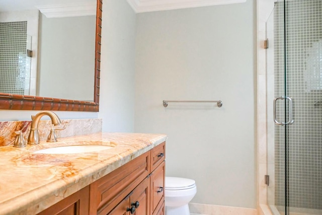 bathroom featuring vanity, a shower with shower door, ornamental molding, and toilet