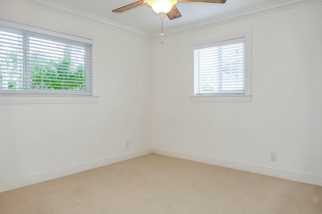 carpeted empty room featuring crown molding and ceiling fan