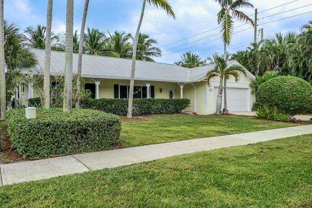 ranch-style house with a garage and a front lawn