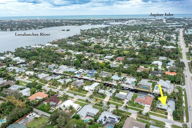 birds eye view of property with a water view