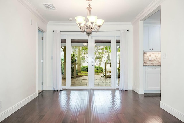 interior space featuring crown molding, dark hardwood / wood-style floors, and an inviting chandelier