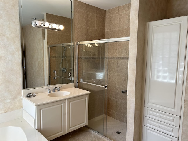 bathroom featuring vanity, tile patterned flooring, and walk in shower