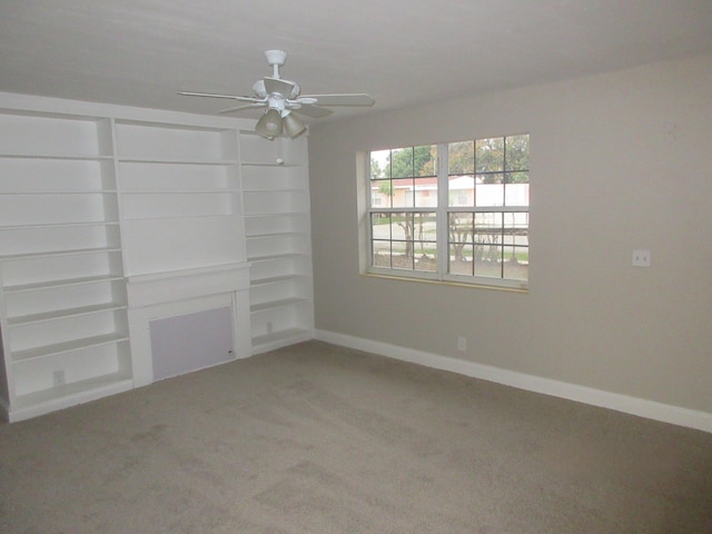 unfurnished living room with ceiling fan and carpet