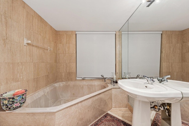 bathroom with tile walls and a relaxing tiled tub