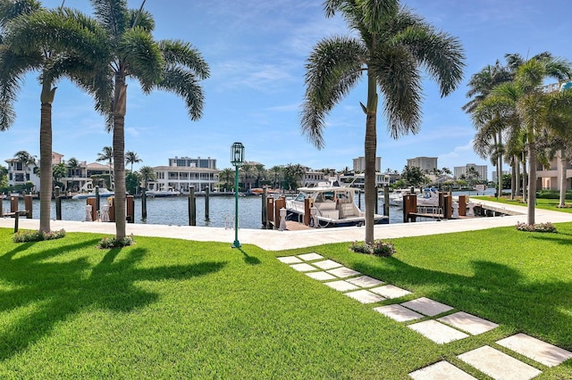 view of yard with a boat dock and a water view