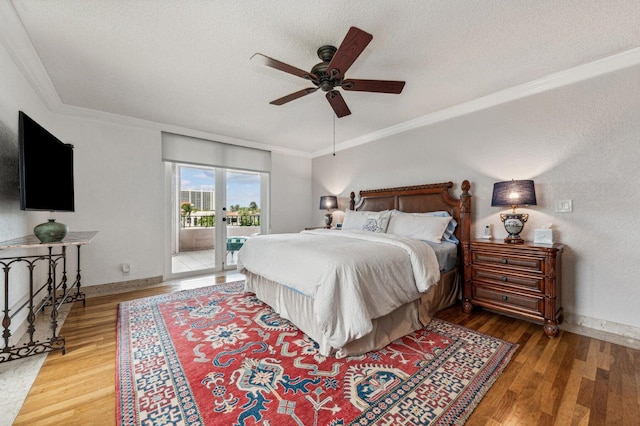 bedroom featuring ornamental molding, wood-type flooring, and access to exterior