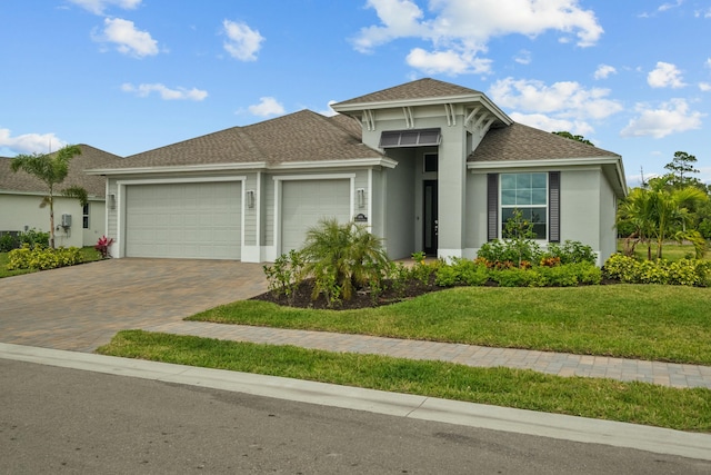 view of front of home with a garage and a front lawn