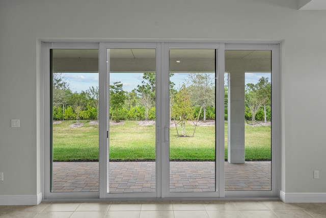 doorway to outside with light tile patterned floors and a healthy amount of sunlight