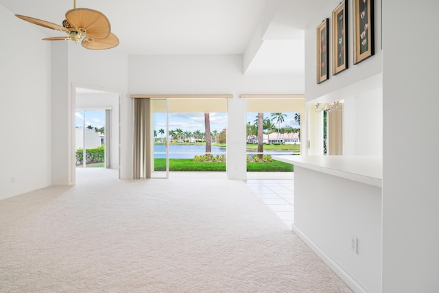 hallway with a water view and light colored carpet