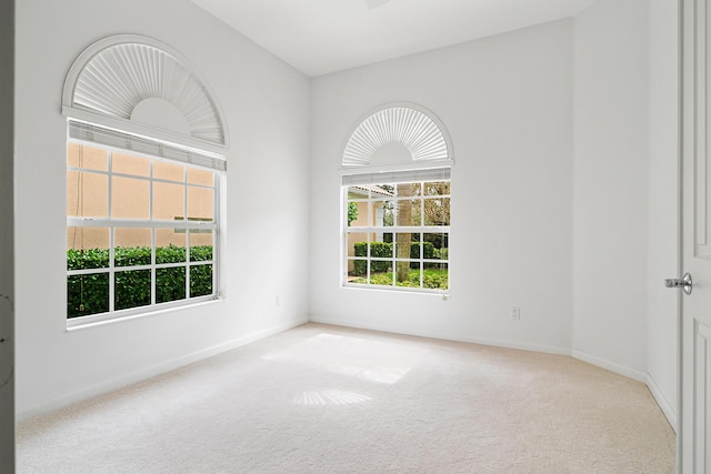 empty room with baseboards and carpet flooring