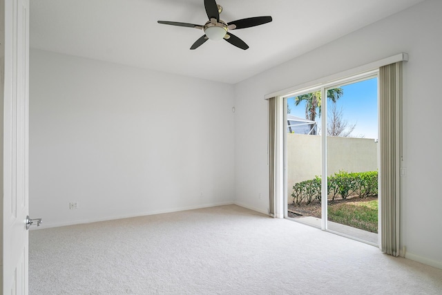 unfurnished room featuring light carpet, a ceiling fan, and baseboards