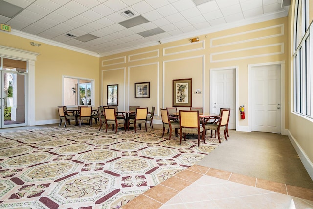 interior space with ornamental molding, visible vents, plenty of natural light, and a towering ceiling